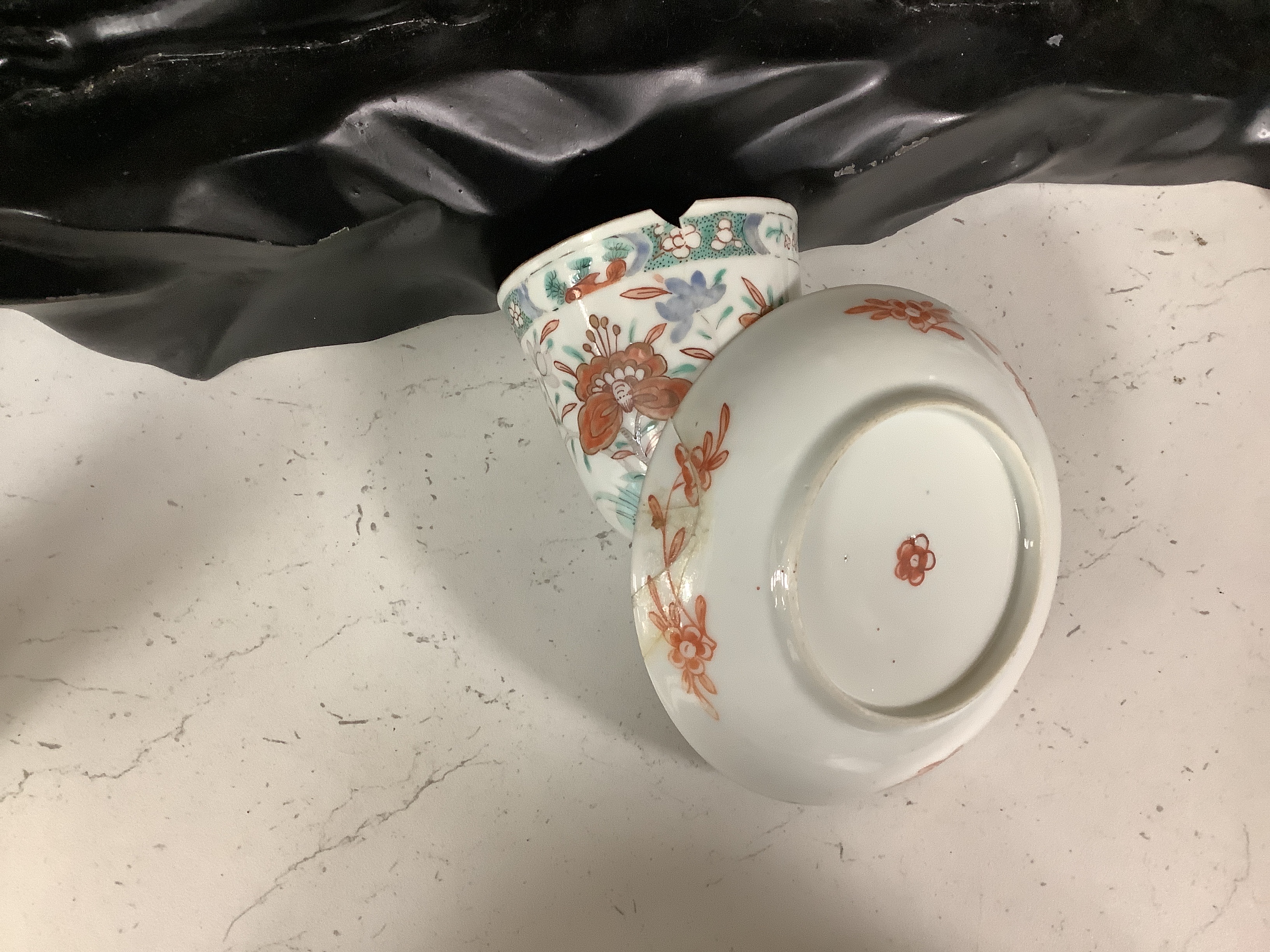 A set of six early 18th century Chinese cups and saucers with Dutch enamelled decoration, c.1710, 7.5cm high